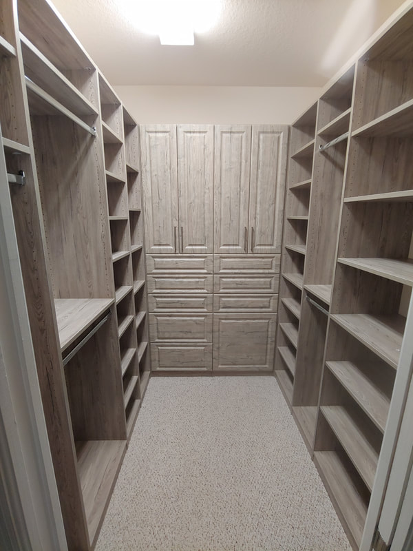Custom walk-in closet with white laminate system in Sarasota FL