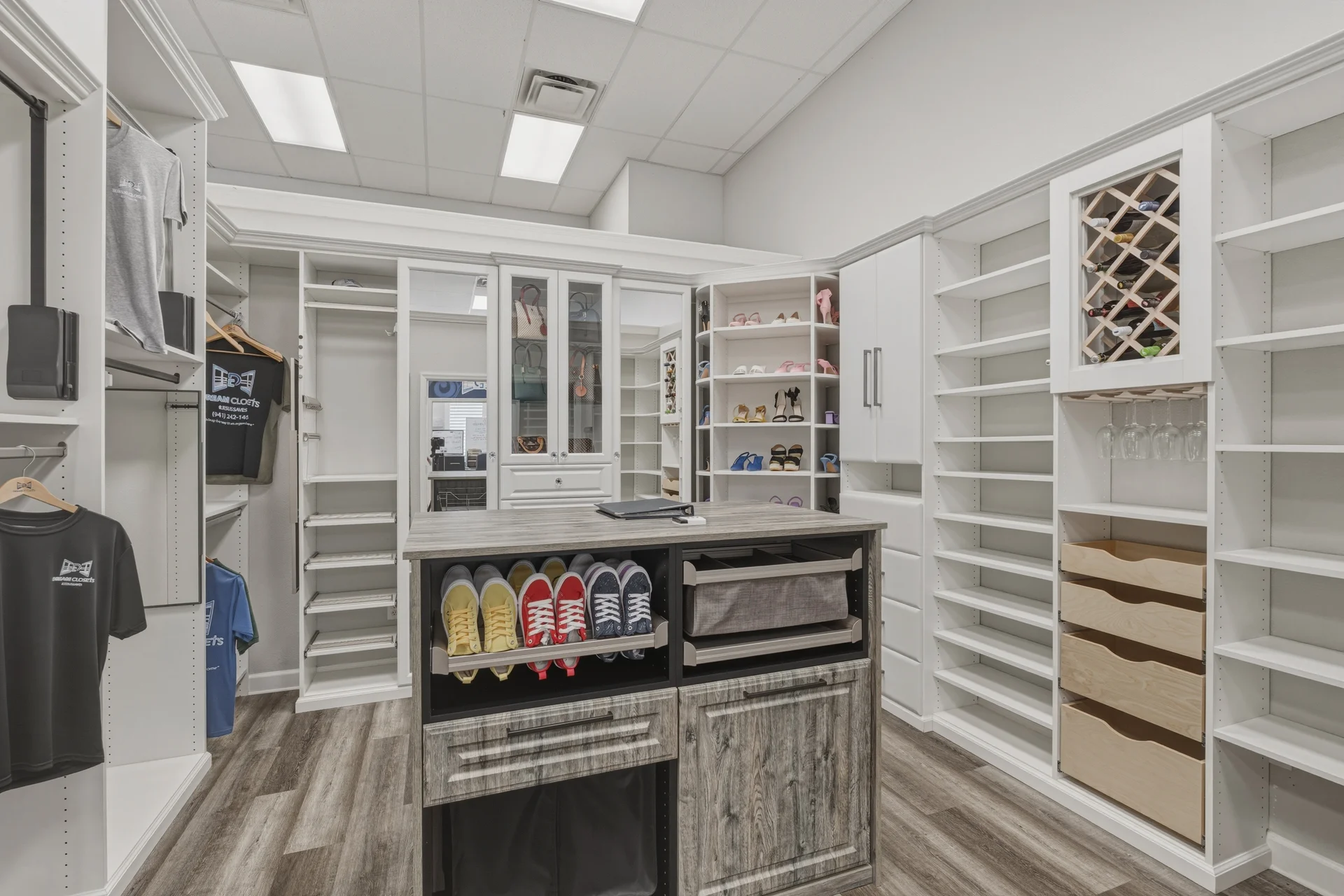Dream Closets LLC showroom walk-in closet display with island, shoe storage, and wine rack in Bradenton FL