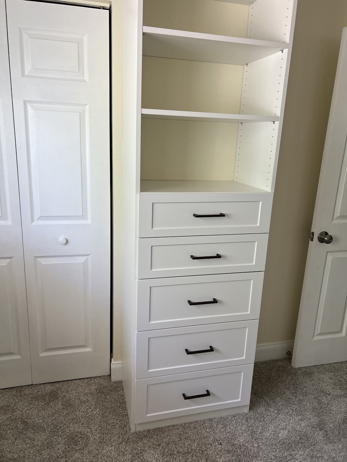 Reach-in closet drawer tower with shaker-style fronts and matte black hardware in Lakewood Ranch FL